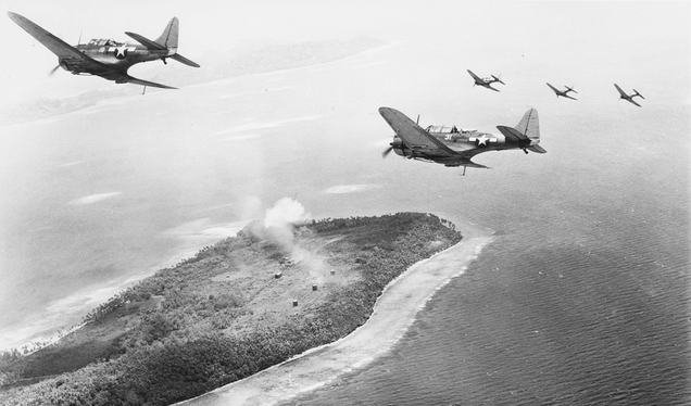 US Navy Douglas SBD-5 Dauntless dive bombers of bombing squadron VB-16 flying from USS Lexington (CV-16) attack Japanese installations on Param Island, Truk Atoll in February 1944 (US Navy)